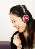 18126718-young-woman-feeling-happy-listening-music-with-headphones